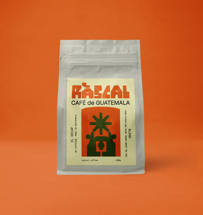 A packaged bag of Ráscal decaf Guatemala coffee with a brutalist graphic on the label.