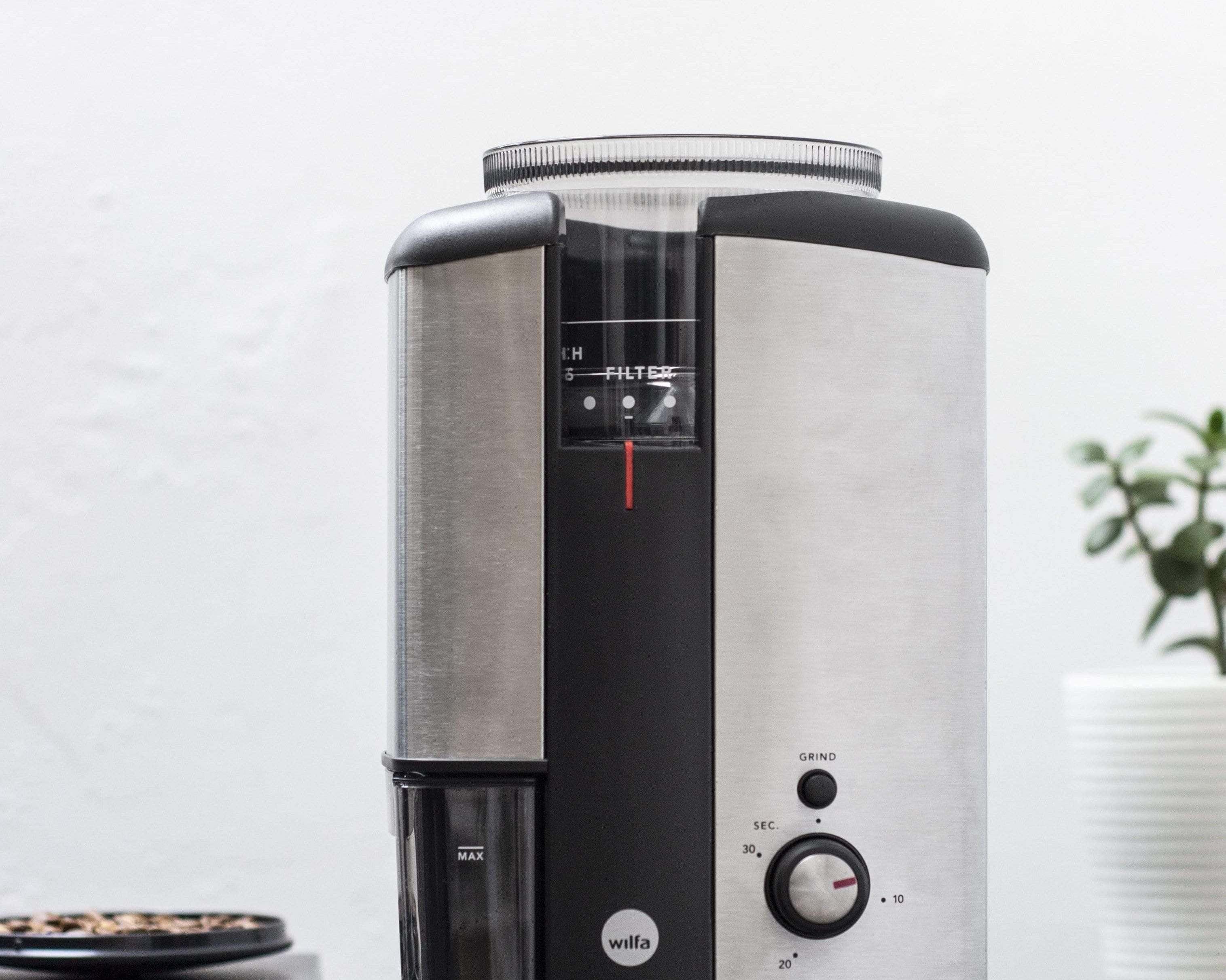 silver wilfa svart electric coffee grinder sitting on black countertop 