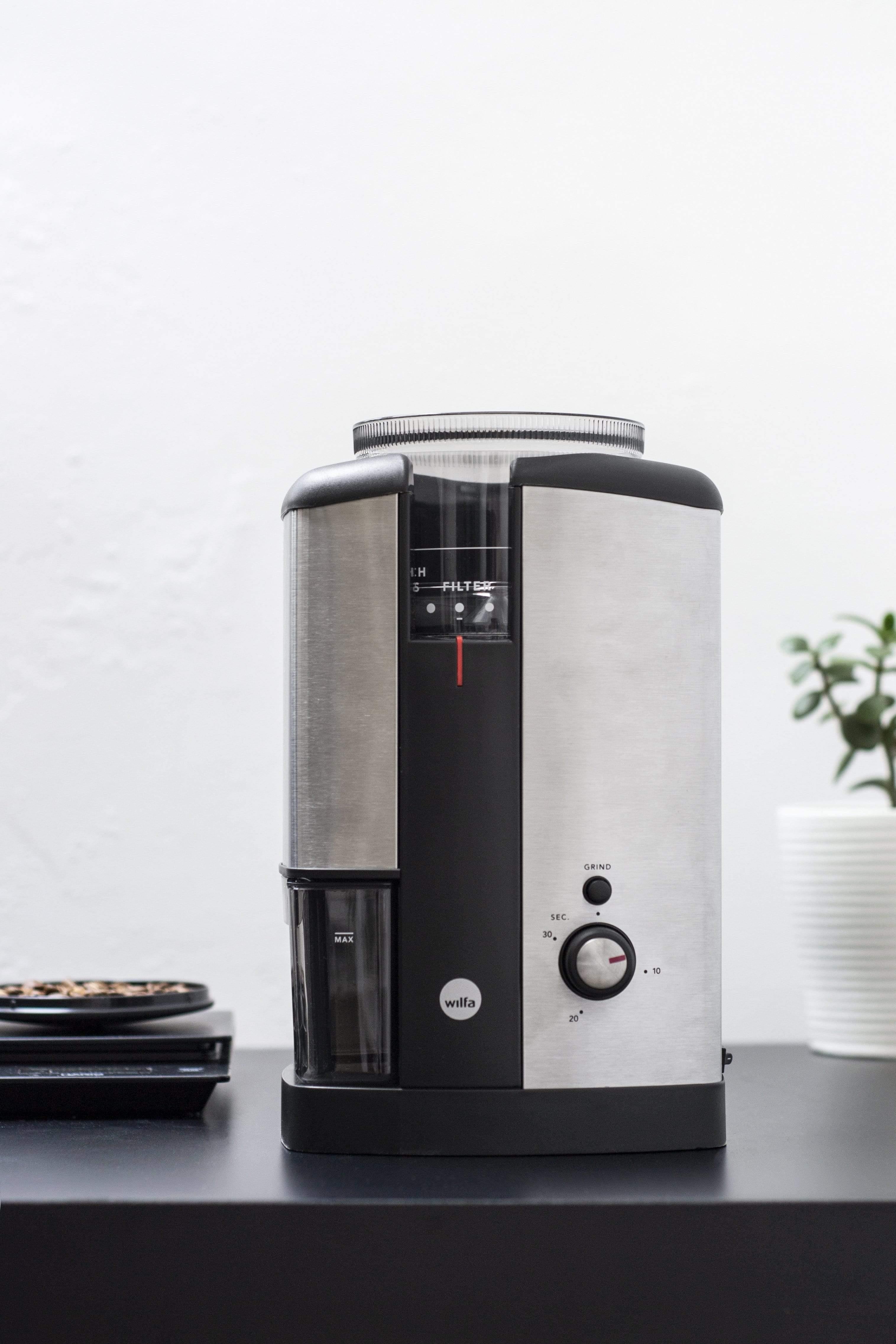 silver wilfa svart electric coffee grinder sitting on black countertop 